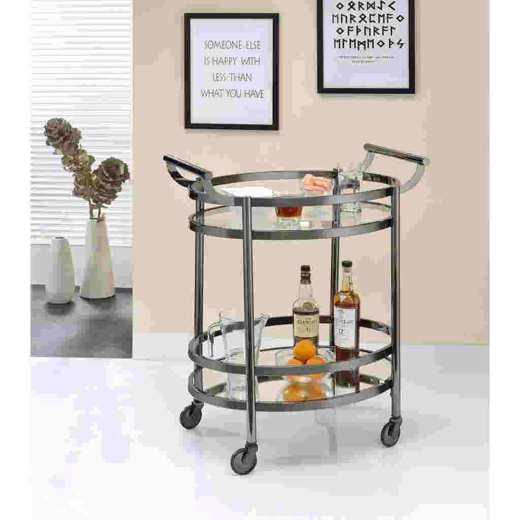A serving cart with bottles and glasses on it, in a living room setting.