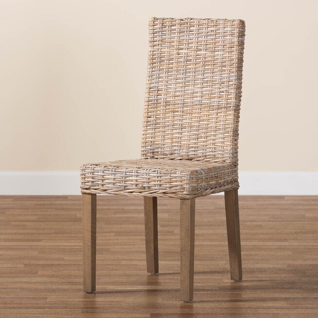 Grey woven dining chair beside wood floor